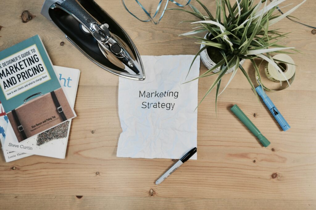 a crumbled paper with "Marketing Strategy" text placed on the desk
