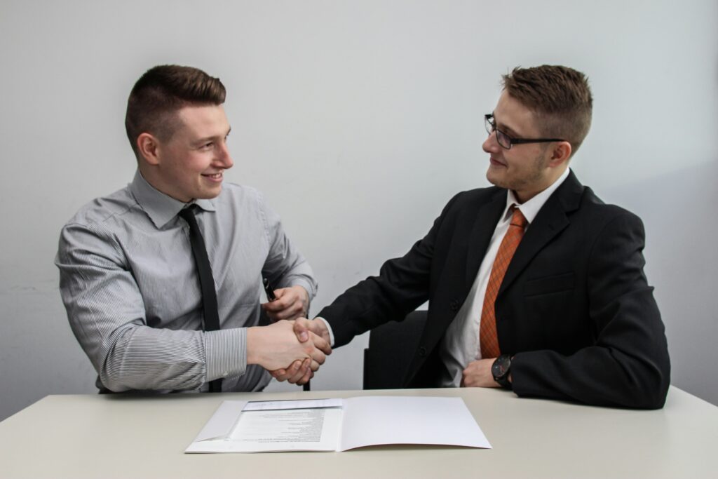 Two businessperson shaking hands in agreement