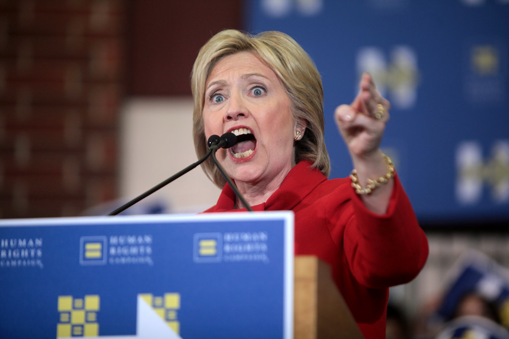 ‘Lock Him Up!’: Hillary Clinton Responds with Silence and Smiles as Chants Mirror Trump Rallies